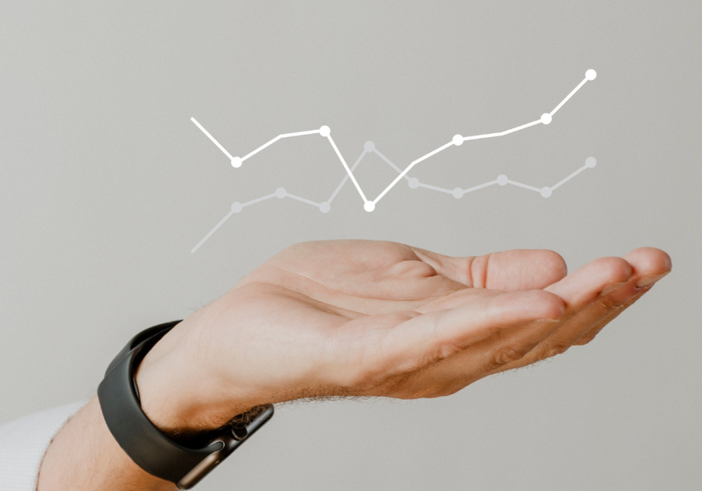 Hand holding a floating line graph representing data trends.