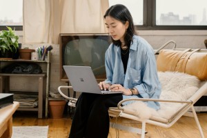 Woman sitting on a chair and working on a laptop
